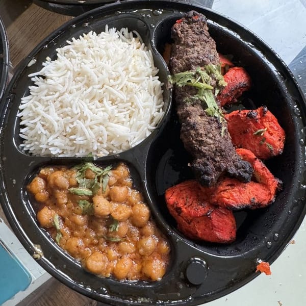 Z Kabob's platter with white rice, chickpea curry, beef kebab, and red chicken tikka.